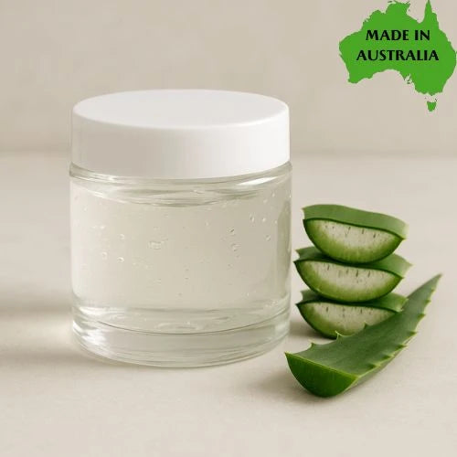 Clear jar with white lid next to aloe vera slices on a beige background, with 'Made in Australia' label.