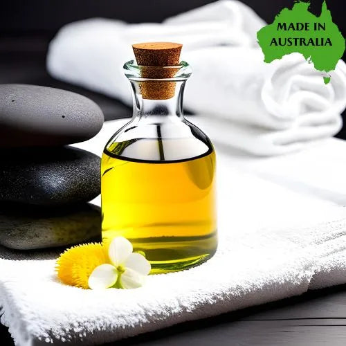 Corked glass bottle of massage bath oil with towels and smooth stones