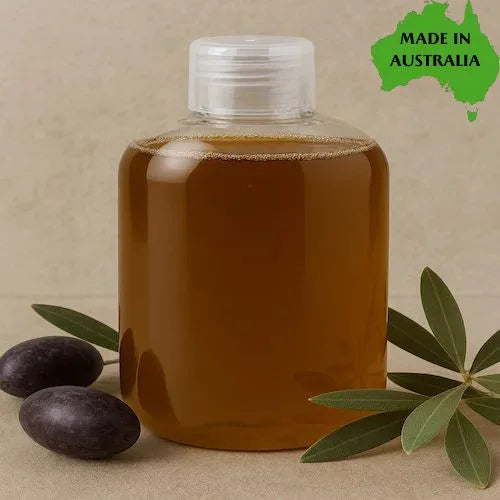 Bottle of traditional liquid castile soap with olives and leaves on a beige background, featuring 'Made in Australia' text.