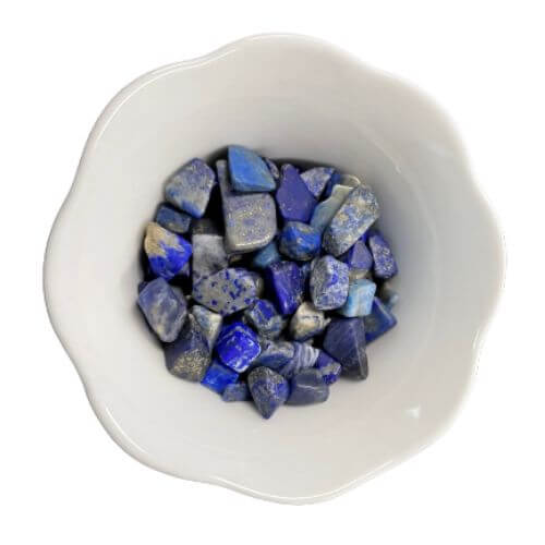White bowl with blue lapis lazuli crystals in it