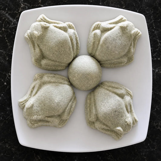 Shower steamers in the shape of frogs and half ball on a white plate