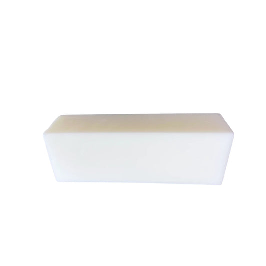 Rectangular white goat milk soap bar on white background