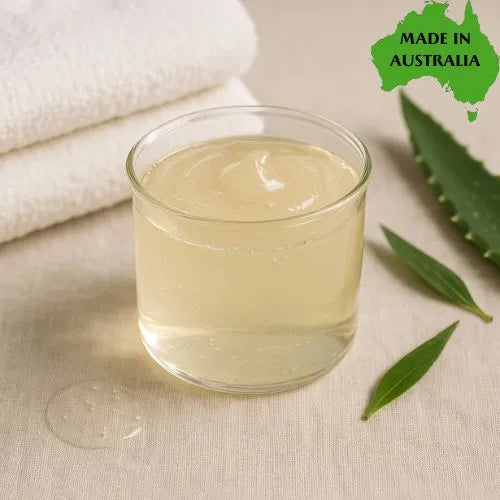 Glass of organic SLES free shower gel with aloe leaves on a beige background, labeled 'Made in Australia'