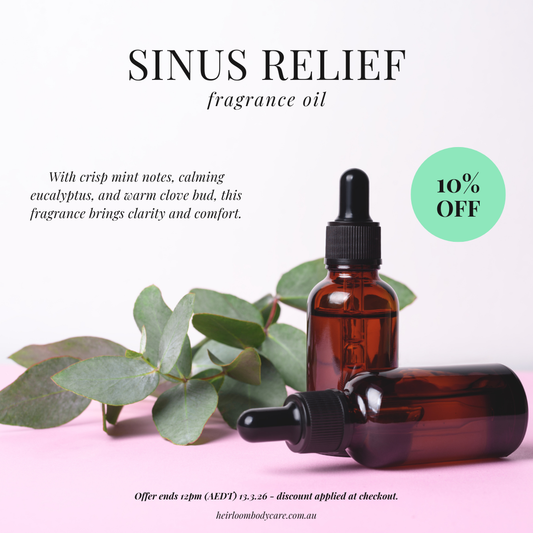 Brown glass bottles with droppers on a pink background with eucalyptus leaves, promoting sinus relief fragrance oil.