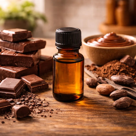 Bottle of chocolate-flavour oil on a wooden surface with chocolate bars and ingredients.