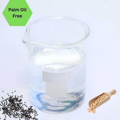 Clear beaker of glycerine with seeds and a scoop on a white background, featuring 'Palm Oil Free' label.