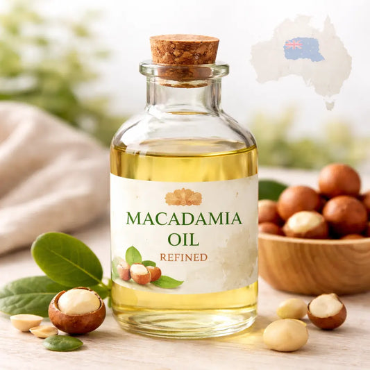 Bottle of macadamia oil with nuts and leaves on a wooden surface