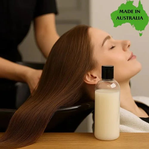 Woman receiving a hair treatment with moisturising conditioner base in front, and a 'Made in Australia' label on a map.