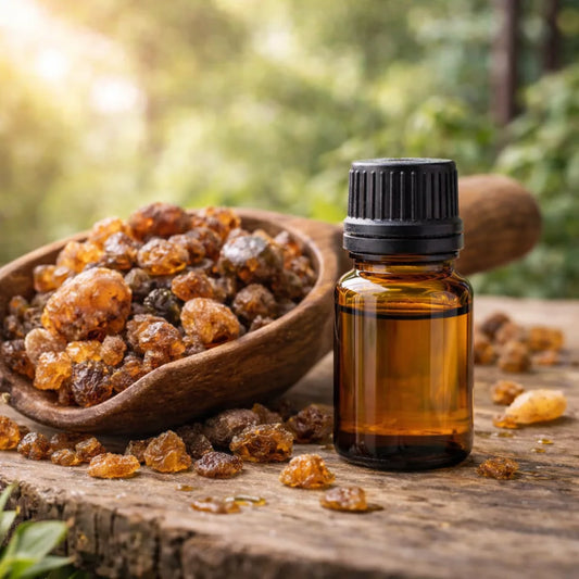 Bottle of essential oil with myrrh resin on a wooden surface
