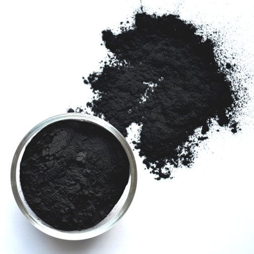 Black 100% activated charcoal in a jar and on white background