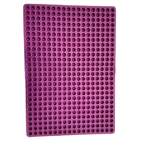 Purple mould mat with hundreds of half circle cavities