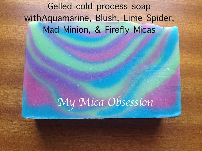 Soap made with aquamarine mica and others in a stripy pattern