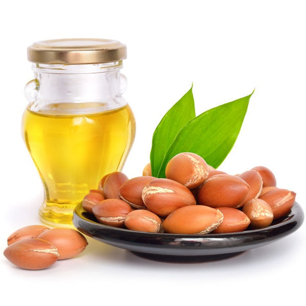 Argan Oil 100% - certified organic and argan nuts on a plate