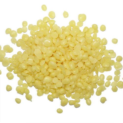 Golden Beeswax Pellets are drops of yellow wax on a white background