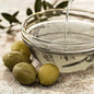 Clear Olive Squalane being poured into a bowl