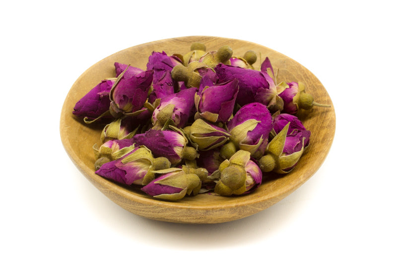 Small red rose buds in a dish